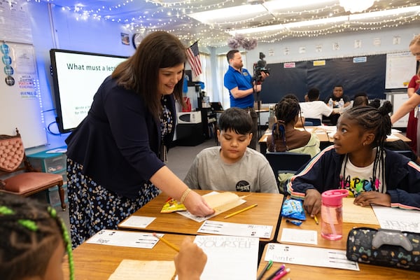 Compton Elementary School Principal Beth Lair looks over Charlie Vega’s letter to his future self on the first day of class Tuesday, Aug. 1, 2023, in Powder Springs. (Ben Gray for The Atlanta Journal-Constitution)