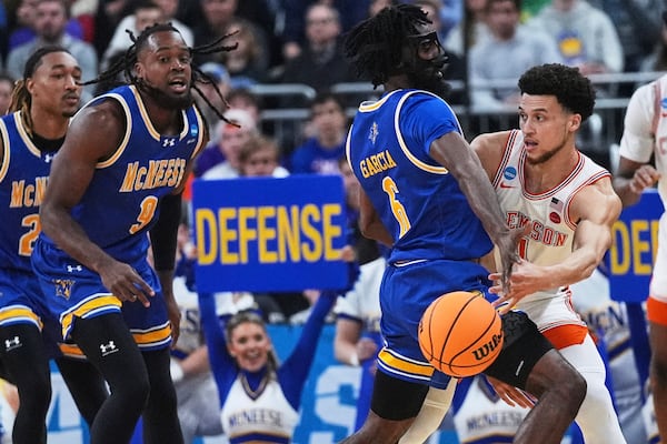 Clemson guard Chase Hunter, right, passes while covered by McNeese State guard Javohn Garcia (6) during the first half in the first round of the NCAA college basketball tournament, Thursday, March 20, 2025, in Providence, R.I. (AP Photo/Charles Krupa)