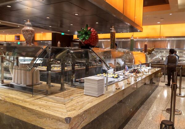 At the Wicked Spoon buffet at The Cosmopolitan, diners can approach the buffet, but staff plates the food from behind stanchions.