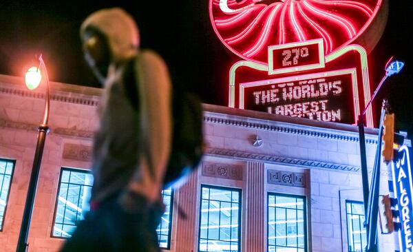 March 16, 2017 Atlanta: Derrick Harrison walks past the Coca-Cola temperature sign near Five Points in downtown Atlanta on the way to work as the temperature dipped down into the twenties on Thursday, March 16, 2017. JOHN SPINK /JSPINK@AJC.COM