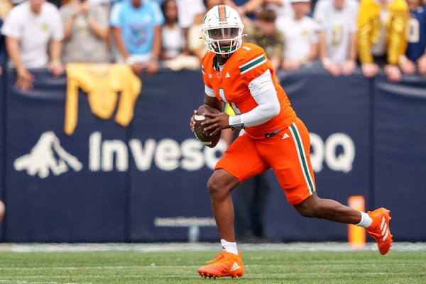 Miami quarterback Cam Ward (1) looks for an open receiver during the first half of an NCAA college football game against the Georgia Tech Yellowjackets, Saturday, Nov. 9, 2024, in Atlanta. (AP Photo/Jason Allen)