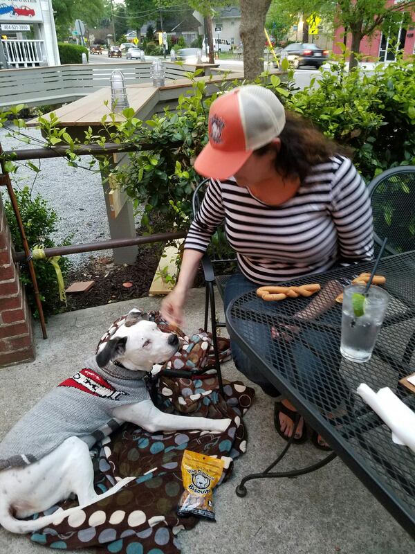 Lauren Janis and Big Daddy of Atlanta-made Big Daddy Biscuits enjoy the patio at East Atlanta Village's Midway Pub.