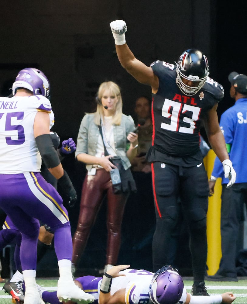 Atlanta Falcons defensive tackle Calais Campbell (93) celebrates stopping Minnesota Vikings quarterback Jaren Hall (16) on a goal line stand during the first quarter of an NFL football game in Atlanta on Sunday, Nov. 5, 2023. (Bob Andres for the Atlanta Journal Constitution)