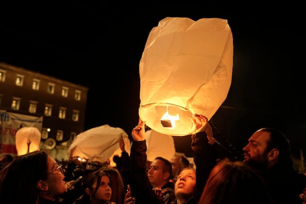 Protesters release lanterns during a rally, after the Greek opposition parties have challenged the country's center-right government with a censure motion in parliament over a devastating rail disaster nearly two years ago, in Athens, Wednesday, March 5, 2025. (AP Photo/Petros Giannakouris)