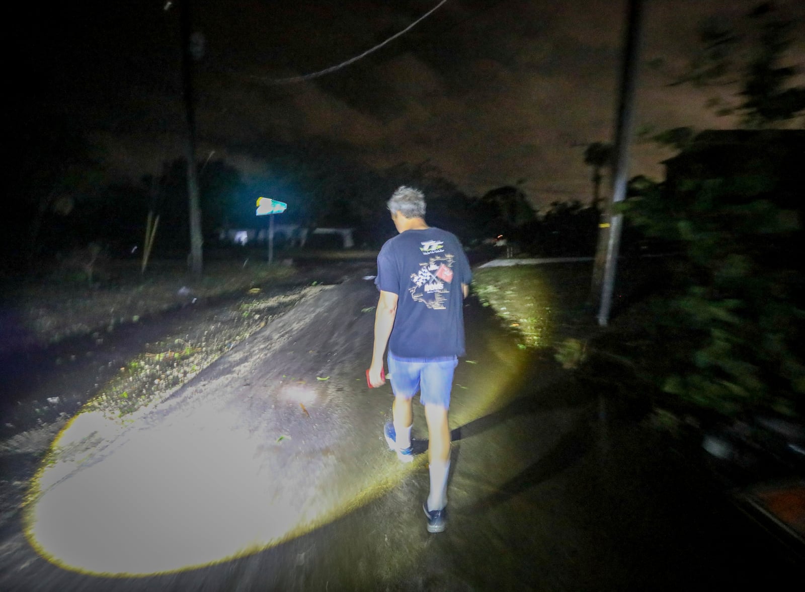 Doug Manning walks to his home along Commonwealth Drive after Hurricane Milton made landfall nearby Thursday, Oct. 10, 2024 in Siesta Key, Fla. (Chris Urso/Tampa Bay Times via AP)