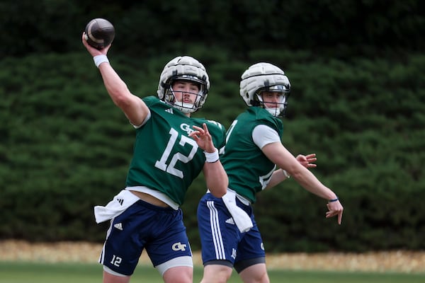 Georgia Tech quarterbacks Aaron Philo (left) and Haynes King air it out during the team's first spring practice on Tuesday.