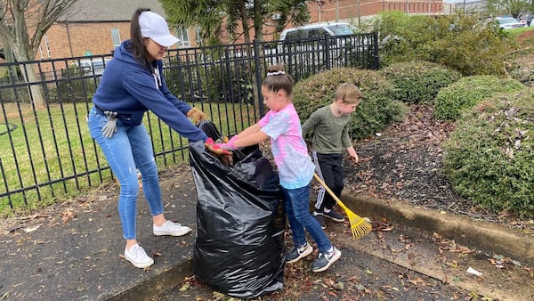 Nikki Affleck and her children, Bailey, 6, and Lawson, 5, help with clean up efforts from the recent tornado at the Newnan Presbyterian School on Saturday, March 27, 2021. ERIC STIRGUS/ESTIRGUS@AJC.COM.