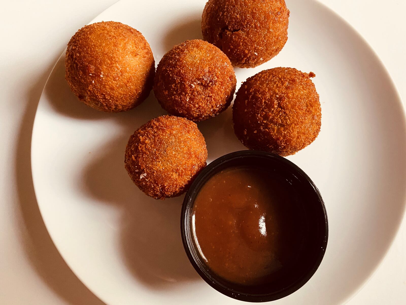 Bitterballen from Bold Monk Brewing Co. comes with smoked brisket, apple mostarda and beet sabayon. Bob Townsend for The Atlanta Journal-Constitution