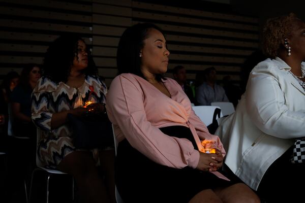 District Attorney Fani Willis holds an electric candle at a vigil for LGBTQ+ victims of crime at Atlanta’s Central Library on Tuesday, June 28, 2022. The vigil was organized by the DA ’s office and its LGBTQ+ advisory committee. (Arvin Temkar / arvin.temkar@ajc.com)