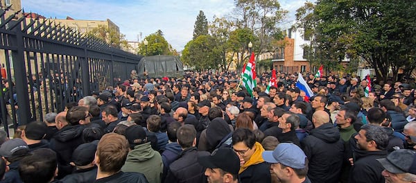 In this photo taken from video released by AIASHARA Independent Agency, Protesters gather outside the parliament building of the Georgian separatist region of Abkhazia as tensions flared over a proposed pact that would allow Russians to buy apartments in the region, Georgia, on Friday, Nov. 15, 2024. (AIASHARA Independent Agency via AP)