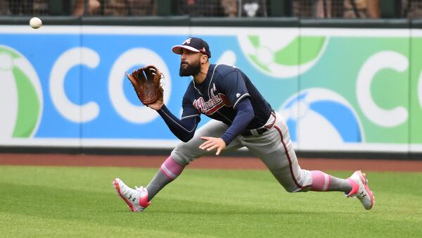 Braves right fielder Nick Markakis makes a diving catch on a line drive hit by Arizona's Wilmer Flores during the fifth inning  May 12, 2019, at Chase Field in Phoenix,.