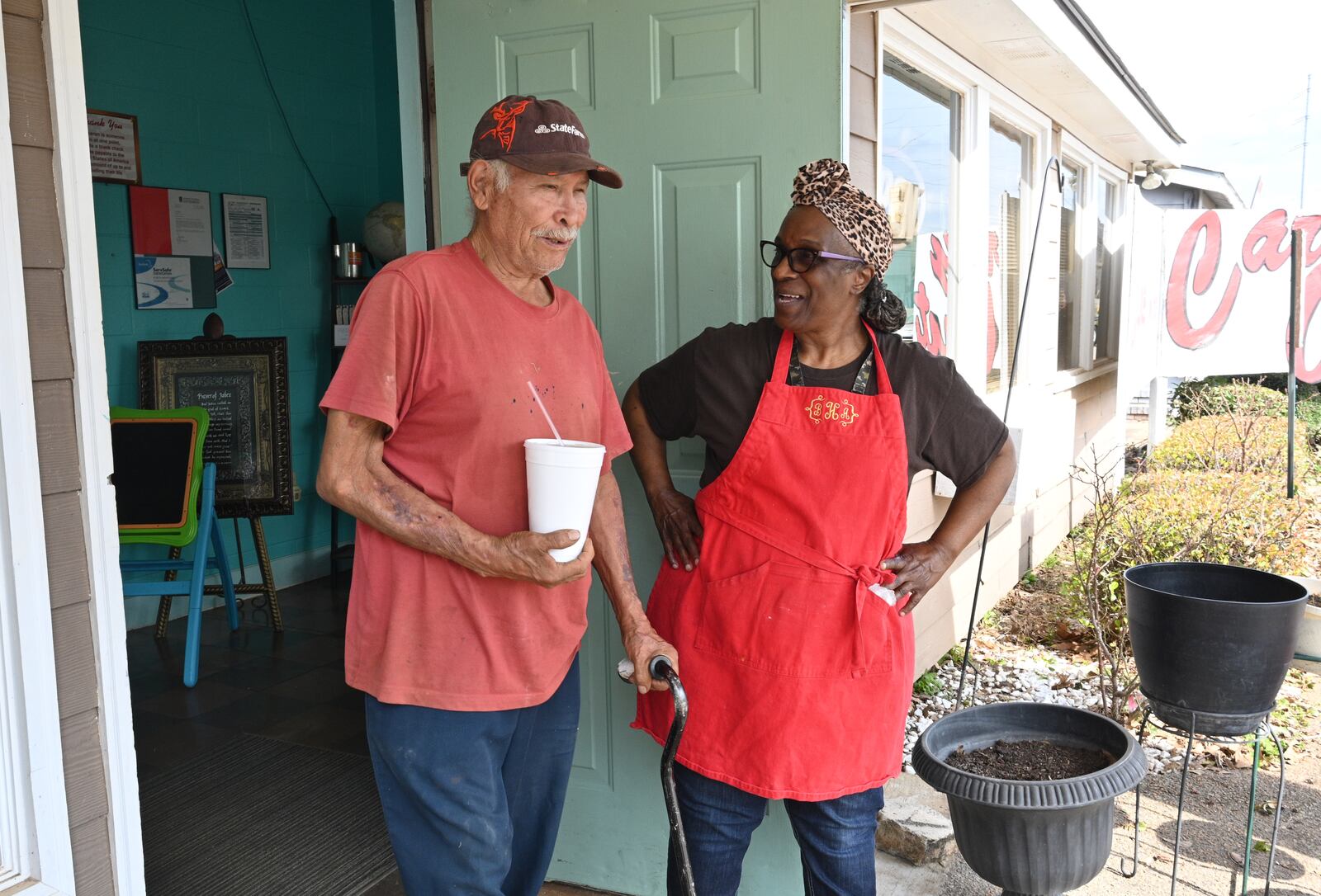 Bonita Hightower (right), owner of Bonita’s Carry-Out, greets regular Nicholas Castro, who lives in Perry but works in Plains area, at Bonita’s Carry-Out, Tuesday, Feb. 21, 2023, in Plains, GA. (Hyosub Shin / Hyosub.Shin@ajc.com)