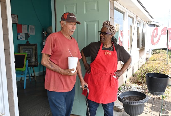 Bonita Hightower (right), owner of Bonita’s Carry-Out, greets regular Nicholas Castro, who lives in Perry but works in Plains area, at Bonita’s Carry-Out, Tuesday, Feb. 21, 2023, in Plains, GA. (Hyosub Shin / Hyosub.Shin@ajc.com)