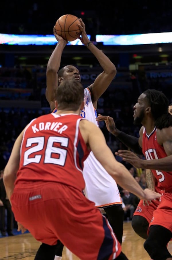 Oklahoma City Thunder forward Kevin Durant (35) shoots over Atlanta Hawks guard Kyle Korver (26) and DeMarre Carroll (5) to take the lead during the fourth quarter of an NBA basketball game, Monday, Jan. 27, 2014, in Oklahoma City. Oklahoma City won 111-109. (AP Photo/Alonzo Adams) This would be your game-winner. (Alonzo Adams/AP.)