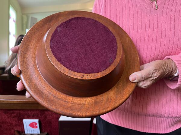 Jimmy Carter carved his initials into the wooden collection plate at Maranatha.