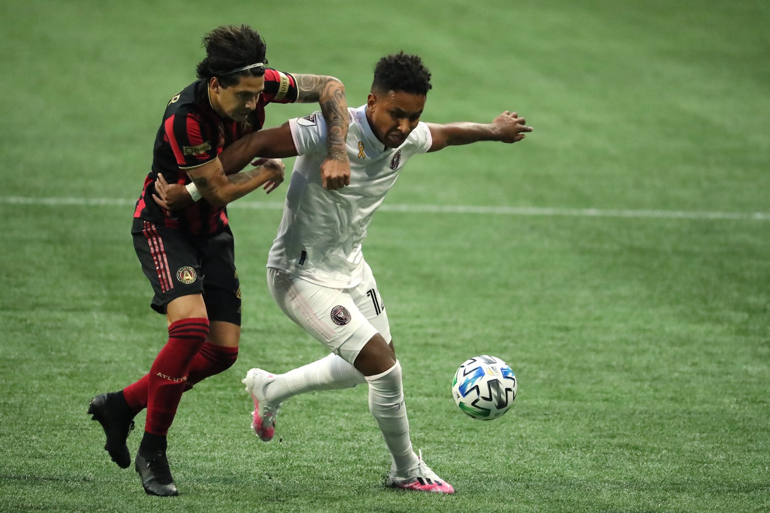 Miami forward Juan Agudelo (12) controls the ball against Atlanta United defender Franco Escobar (2) in the first half at Mercedes-Benz Stadium Saturday, September 19, 2020 in Atlanta. Atlanta United lost 2-1. JASON GETZ FOR THE ATLANTA JOURNAL-CONSTITUTION