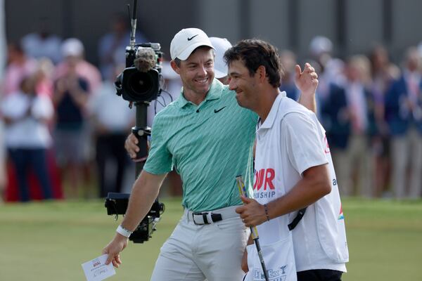 082822 Atlanta, Ga.: Rory McIlroy celebrates with his caddie Harry Diamond after McIlroy won the Tour Championship during the final round at East Lake Golf Club, Sunday, Aug. 28, 2022, in Atlanta. (Jason Getz / Jason.Getz@ajc.com)