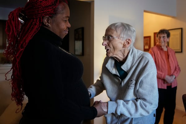 Zuleika, an immigrant from Central America seeking asylum, visits Sister Pat Murphy, 95, center, and Sister JoAnn Persch, right, 90, nuns with the Sisters of Mercy, at their home Thursday, Feb. 20, 2025, in Alsip, Ill. (AP Photo/Erin Hooley)