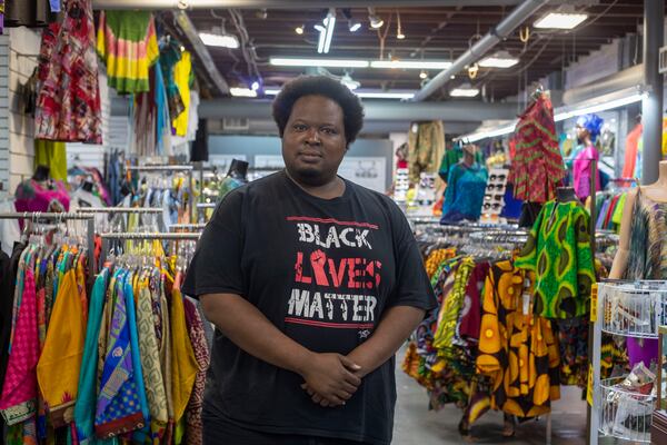 Afro-Centric Network manager Mugaisi Andega stands for a portrait inside his family's store in Atlanta’s West End community, Wednesday, August 25, 2021. (Alyssa Pointer/Atlanta Journal Constitution)