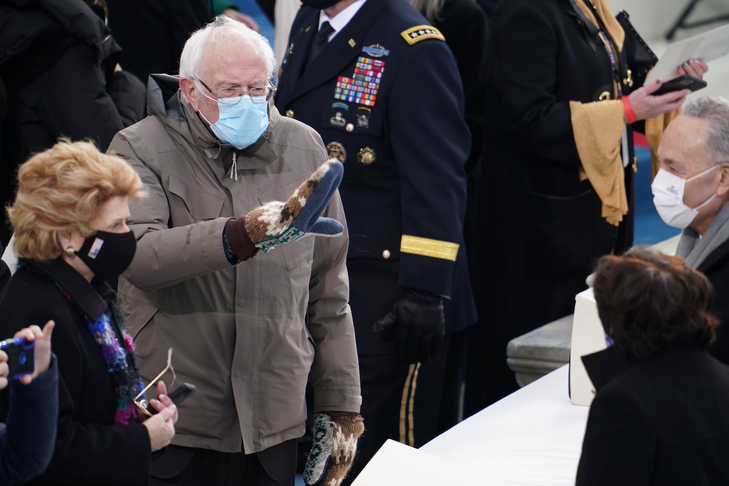 Sen. Bernie Sanders (I-Vt.) waves, along with Sen. Debbie Stabenow (D-Mich.), left, as they attend the inauguration of Joe Biden at the Capitol in Washington on Wednesday, Jan. 20, 2021. (Ruth Fremson/The New York)