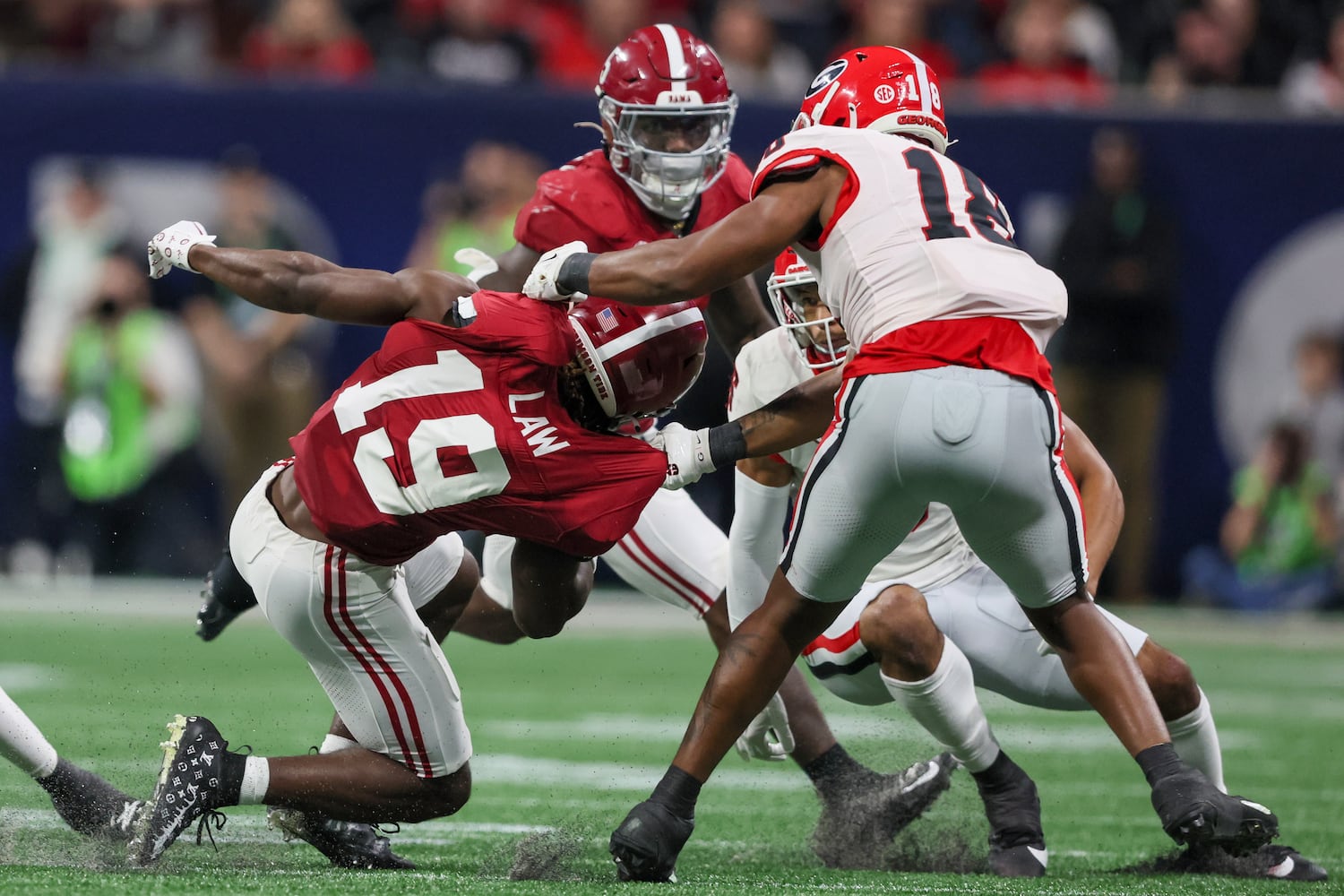 Georgia Bulldogs linebacker Xavian Sorey Jr. (18) brings down Alabama Crimson Tide wide receiver Kendrick Law (19) during the second half of the SEC Championship football game at the Mercedes-Benz Stadium in Atlanta, on Saturday, December 2, 2023. (Jason Getz / Jason.Getz@ajc.com)