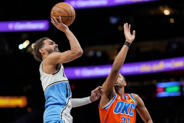 Atlanta Hawks guard Trae Young (11) shoots against Oklahoma City Thunder guard Aaron Wiggins (21) during the first half of an NBA basketball game, Friday, Feb. 28, 2025, in Atlanta. (AP Photo/Mike Stewart)