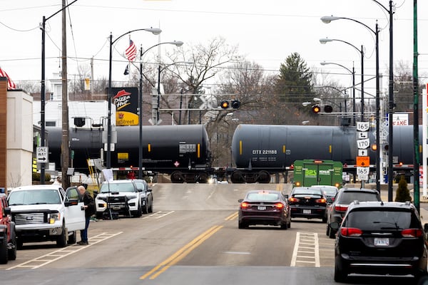 A train passes through East Palestine, Ohio, on Friday, Feb. 17, 2023. Thirty-eight cars of a Norfolk Southern train derailed Feb. 3 in the town. Five hazardous materials cars carrying vinyl chloride were among the cars that derailed. the vinyl chloride was later burned in a controlled burn. (Arvin Temkar / arvin.temkar@ajc.com)