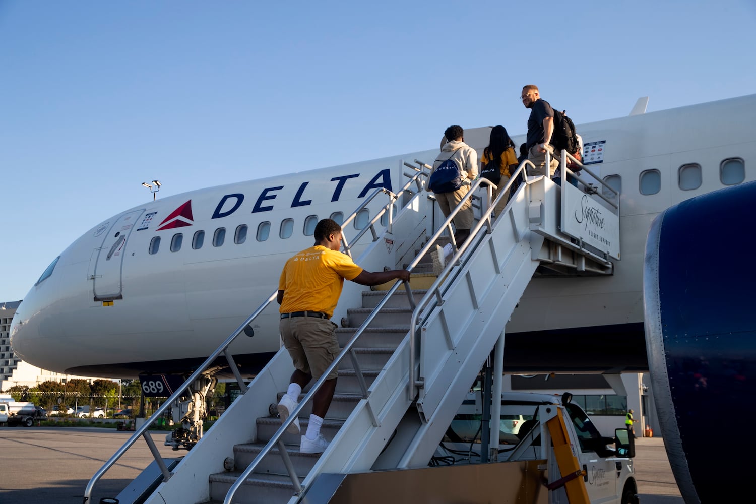 Participants of Delta’s Dream Flight 2022 event board a plane at Hartsfield-Jackson Atlanta International Airport on Friday, July 15, 2022. Around 150 students ranging from 13 to 18 years old will fly from Atlanta to the Duluth Air National Guard Base in Duluth, Minnesota. (Chris Day/Christopher.Day@ajc.com)