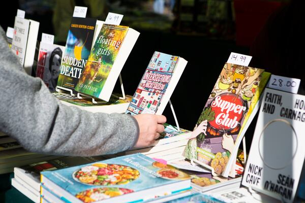 Someone picks up a book during the Decatur Book Festival on Saturday, October 1, 2022, at First Baptist Church of Decatur. The event featured author panels,  live music, food and book vendors. CHRISTINA MATACOTTA FOR THE ATLANTA JOURNAL-CONSTITUTION.