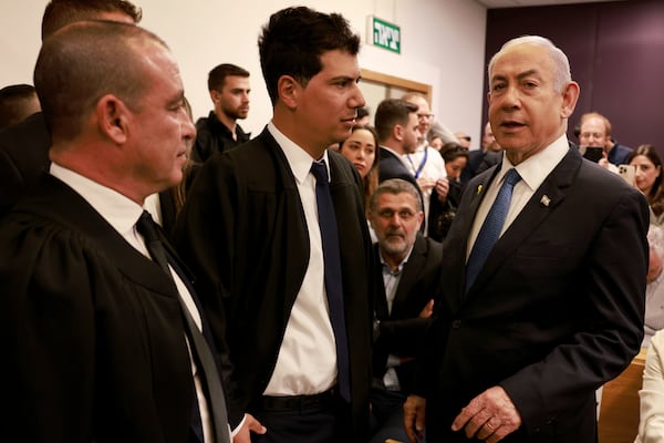 Israeli Prime Minister Benjamin Netanyahu, right, arrives at the district court for his long-running trial for alleged corruption, in Tel Aviv, Israel, Tuesday, Dec. 10, 2024. (Menahem Kahana/Pool Photo via AP)