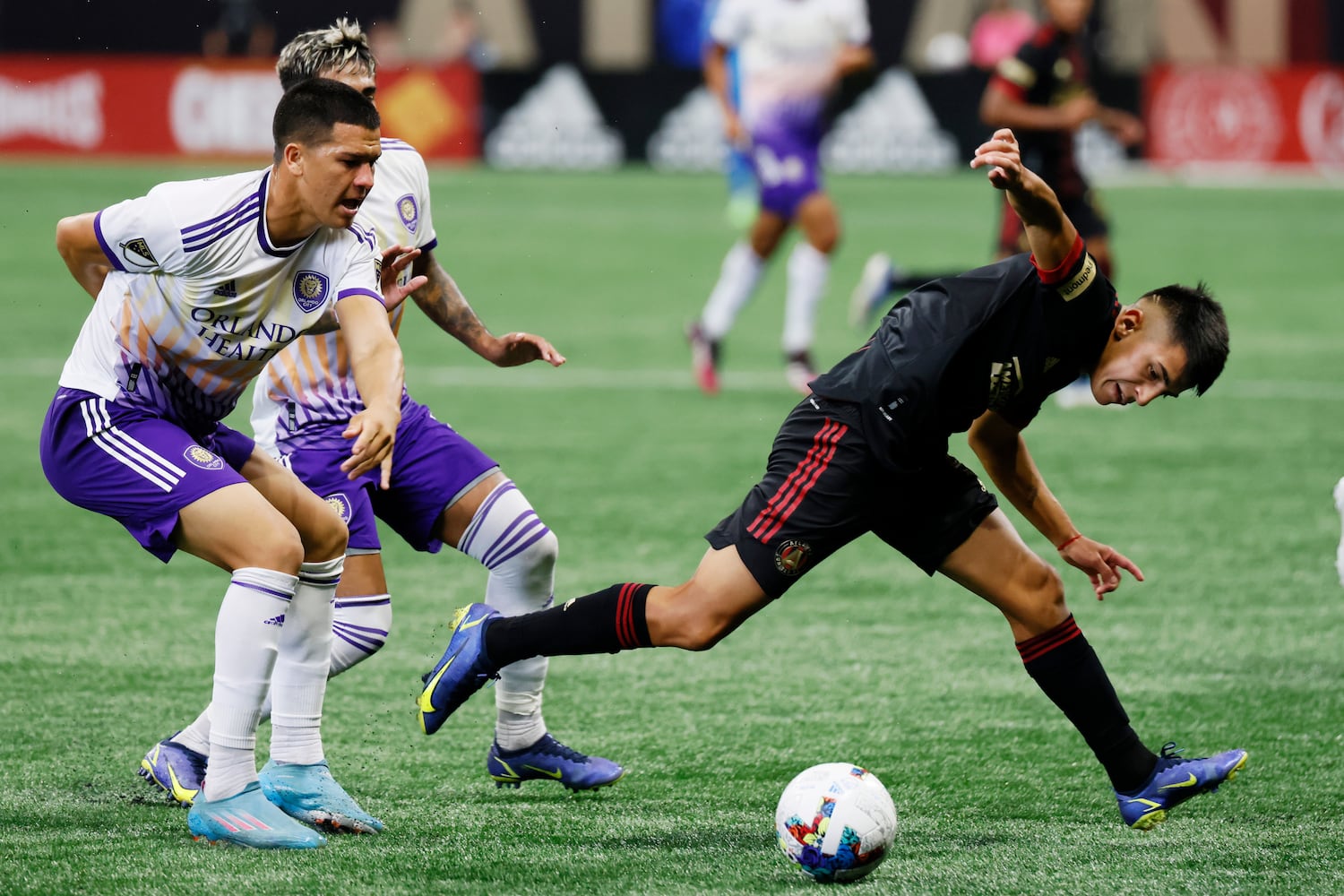 Atlanta United's Thiago Almada battles for the ball against Orlando defenders during the second half of an MLS game Sunday at Mercedes-Benz Stadium. (Miguel Martinez /Miguel.martinezjimenez@ajc.com)