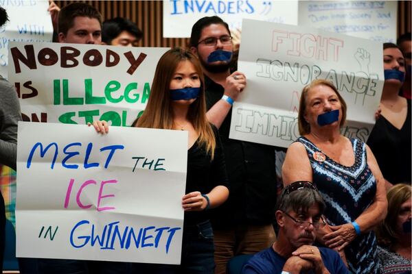 Angela Jiang, center, from Duluth, holds up a sign opposing ICE during a community engagement discussion on immigration organized by Gwinnett Commissioner Marlene Fosque at the Gwinnett Justice and Administration Center on Wednesday, July 31, 2019, in Lawrenceville. ELIJAH NOUVELAGE/SPECIAL TO THE AJC