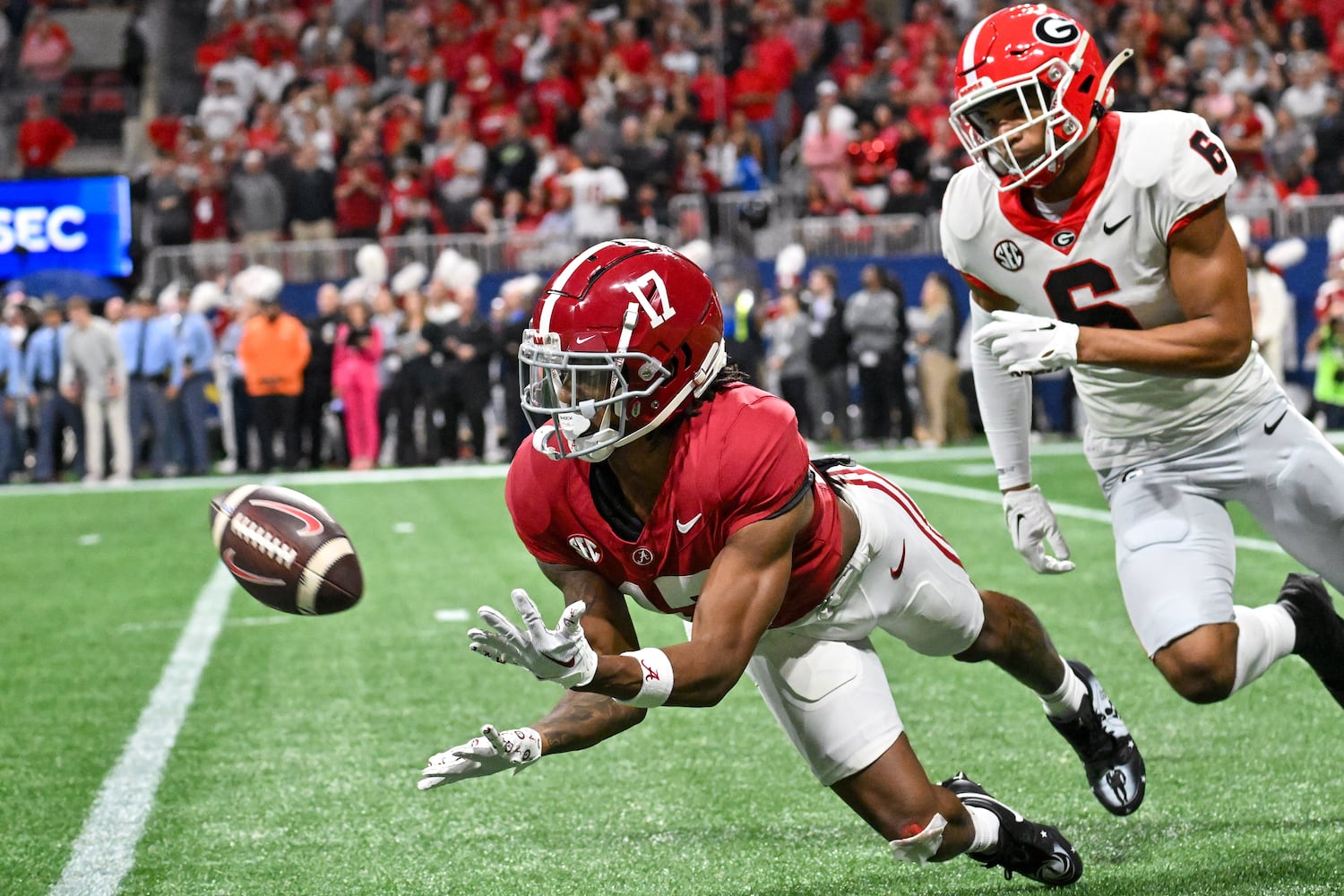 Alabama Crimson Tide wide receiver Isaiah Bond (17) makes a catch in front of Georgia Bulldogs defensive back Daylen Everette (6) during the first half of the SEC Championship football game at the Mercedes-Benz Stadium in Atlanta, on Saturday, December 2, 2023. (Hyosub Shin / Hyosub.Shin@ajc.com)