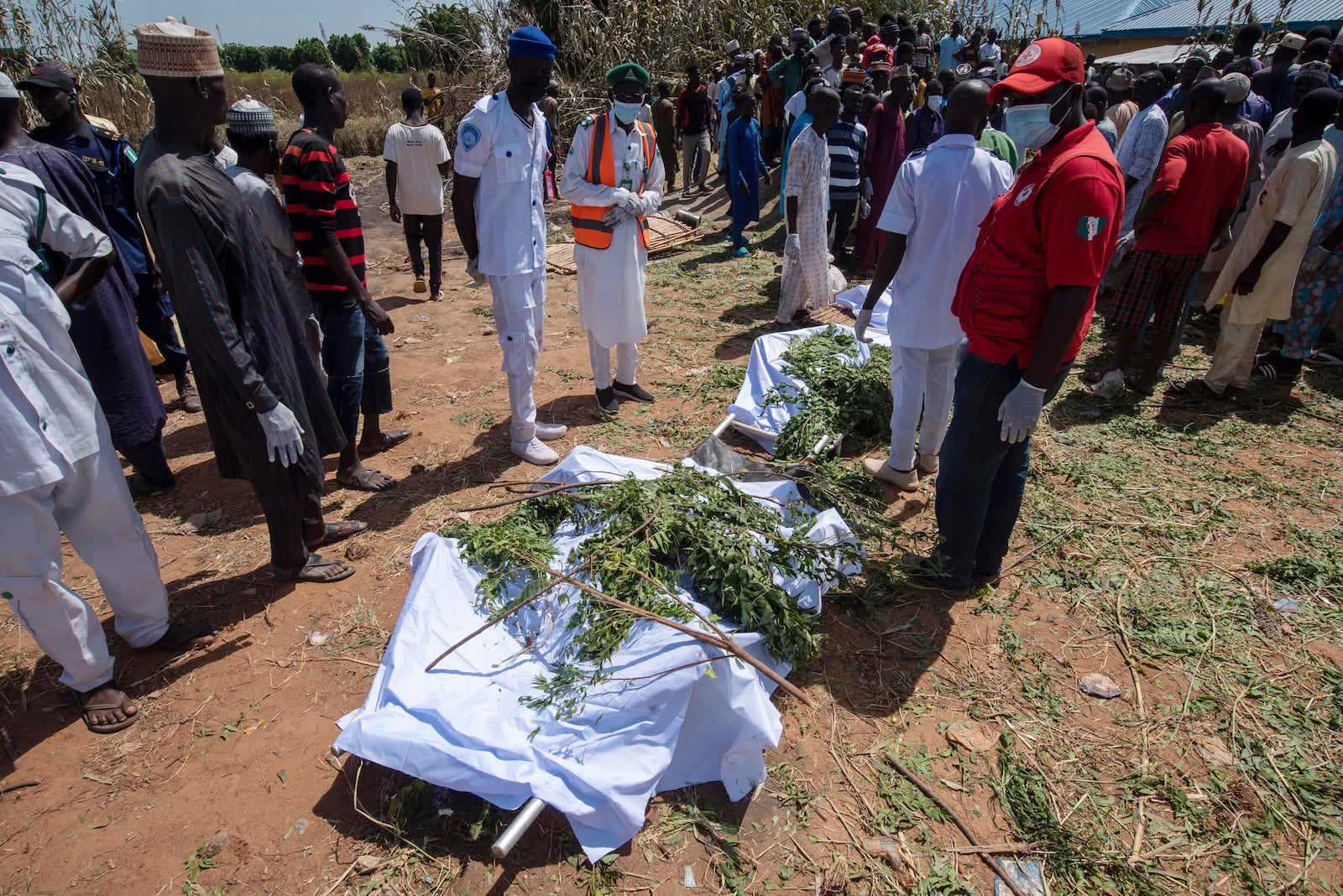 People prepare bodies for burial following a tanker explosion in Majiya town, Nigeria, Wednesday, Oct. 16, 2024. (AP Photo/Sani Maikatanga)