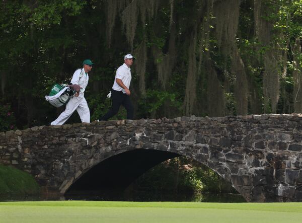 Ryan Fox and caddie Dean Smith cross over the Nelson Brdige  at the 2024 Masters Tournament at Augelson Bridge Augusta National Golf Club, Thursday, April 11, 2024, in Augusta, Ga. Jason Getz / Jason.Getz@ajc.com)
