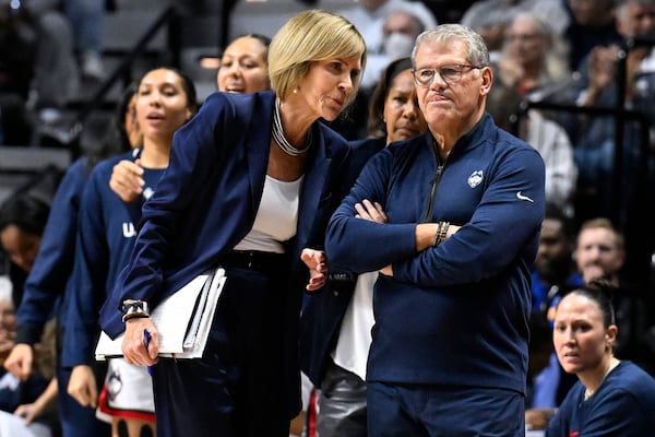 FILE - UConn associate head coach Chris Dailey speaks with UConn head coach Geno Auriemma during the first half of an NCAA college basketball game against North Carolina, Sunday, Dec. 10, 2023, in Uncasville, Conn. (AP Photo/Jessica Hill, File)