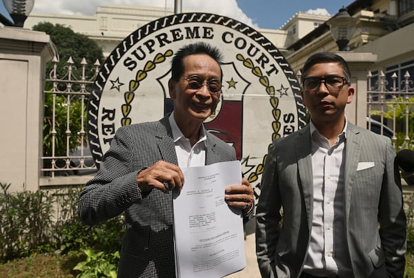 Salvador Panelo, former presidential spokesman and chief presidential legal counsel of Philippine former President Rodrigo Duterte, shows a copy of the Habeas Corpus petition before filing it at the Supreme Court on Wednesday, March 11, 2025 in Manila, Philippines (AP Photo/Noel Celis)