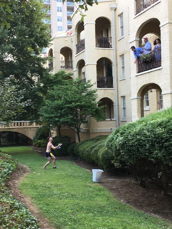 Southern hospitality is aplenty at the 2018 AJC Peachtree Road Race as onlookers toss a runner a beer.