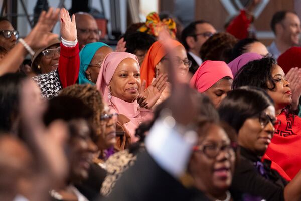 The audience reacts as Karen Briggs plays “Lift Every Voice and Sing” on violin during the Dr. Martin Luther King Jr. Day program at Ebenezer Baptist Church in Atlanta on Monday, Jan. 15, 2024.   (Ben Gray / Ben@BenGray.com)