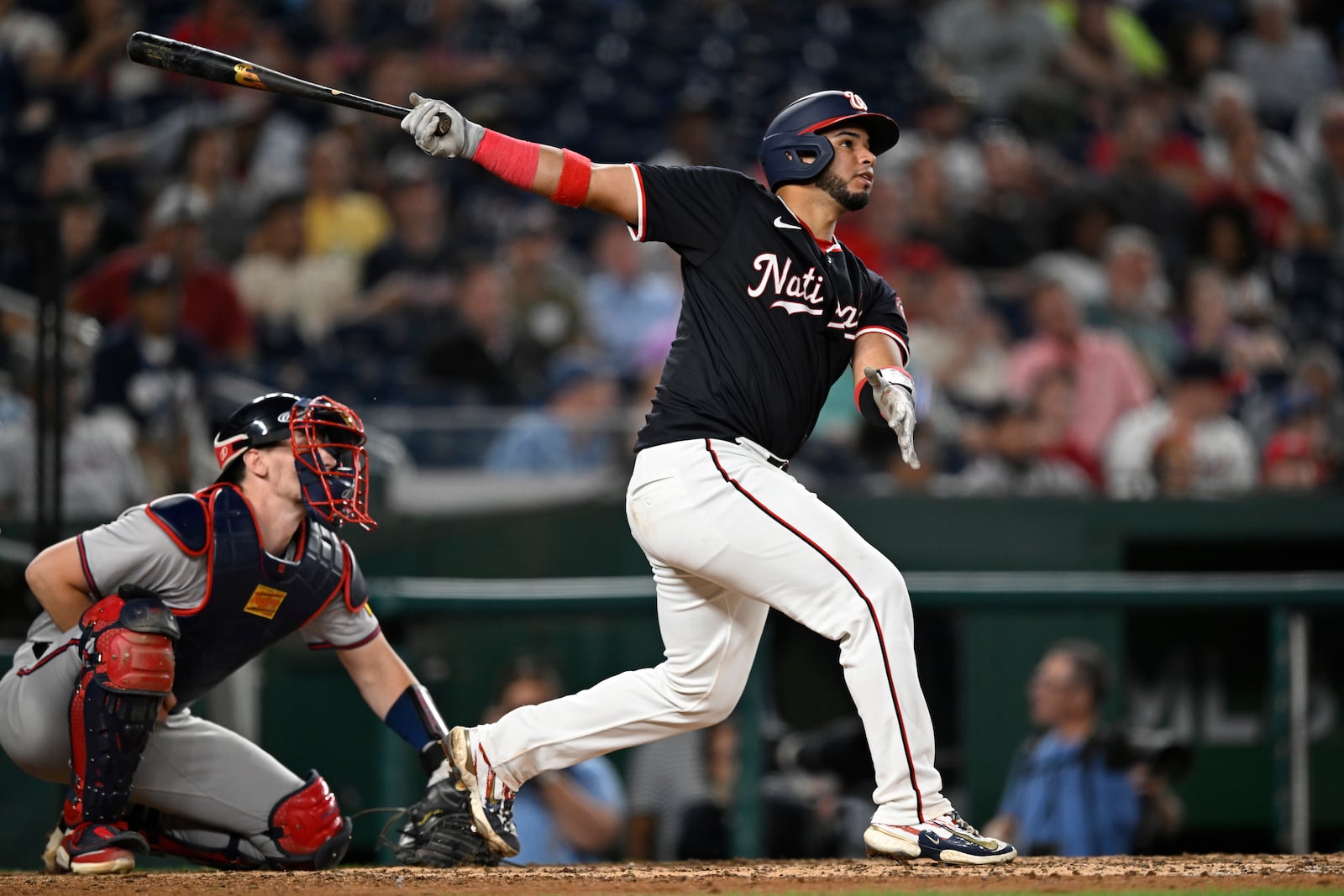 Atlanta Braves catcher Sean Murphy, left, watches the flight of Washington Nationals' Keibert Ruiz's RBI single to right field during the eighth inning of a baseball game, Wednesday, Sept. 11, 2024, in Washington. (AP Photo/John McDonnell)