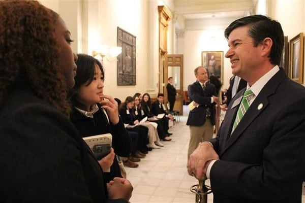 Coweta County teens Cameron Hammett, foreground, and Hannah Lee talk to Sen. Matt Brass, R-Newnan, about proposed voucher legislation at the General Assembly on Thursday, March 2.