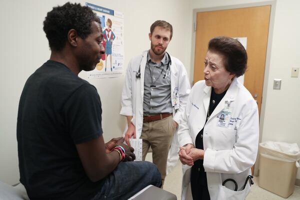 Dr. Nanette Wenger, a cardiologist, right, talks with patient Renard Quinn at Grady Hospital. Also pictured is Resident Physician Brad Witbrodt, center. PHOTO / JASON GETZ