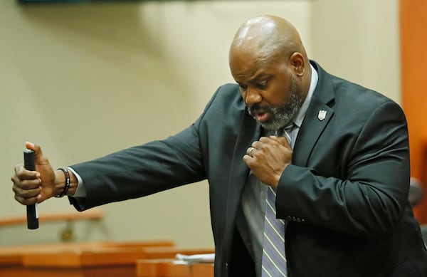 October 2, 2019 - Decatur -   DeKalb Police Sgt. J.K. Walker testifies about DeKalb Police use of force policies and demonstrates the use of an expandable baton.  Former DeKalb County police officer Robert "Chip" Olsen is on trial for murder in the 2015 shooting of war veteran Anthony Hill.  Bob Andres / robert.andres@ajc.com