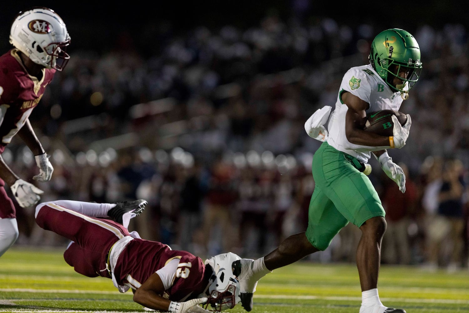 Buford’s Justin Baker (2) pulls a tackler. (Photo/Jenn Finch, AJC)