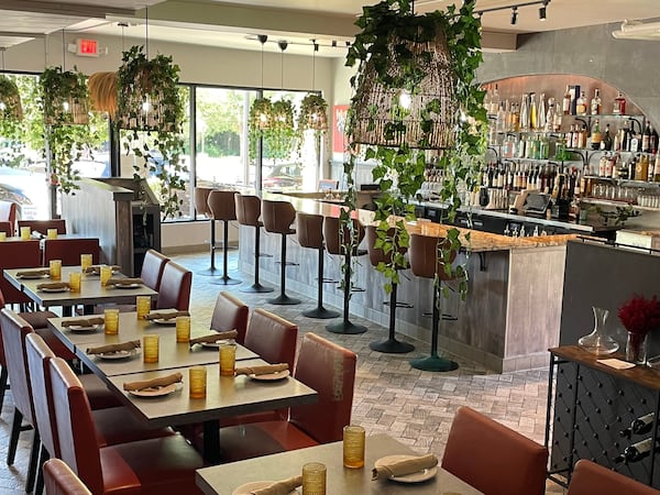 The 60-seat dining room at La Panarda is bright with natural light and hanging greenery. Courtesy of La Panarda