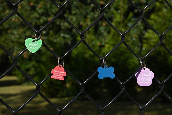 October 26, 2022 McDonough - Other pet owners have hung their pets' dogtags at a memorial of his German shepherd, Ace, near his office Fallas Family Vision in McDonough on Wednesday, October 26, 2022. The story is about a memorial that Dr. Humberto Fallas (called Peto) created for his German shepherd, Ace, that has become a kind of shrine for others who have lost their pets. About a dozen or so other pet owners have hung their pets' dogtags (and cat-tags) up at the site, memorializing animal friends who have passed away.(Hyosub Shin / Hyosub.Shin@ajc.com)