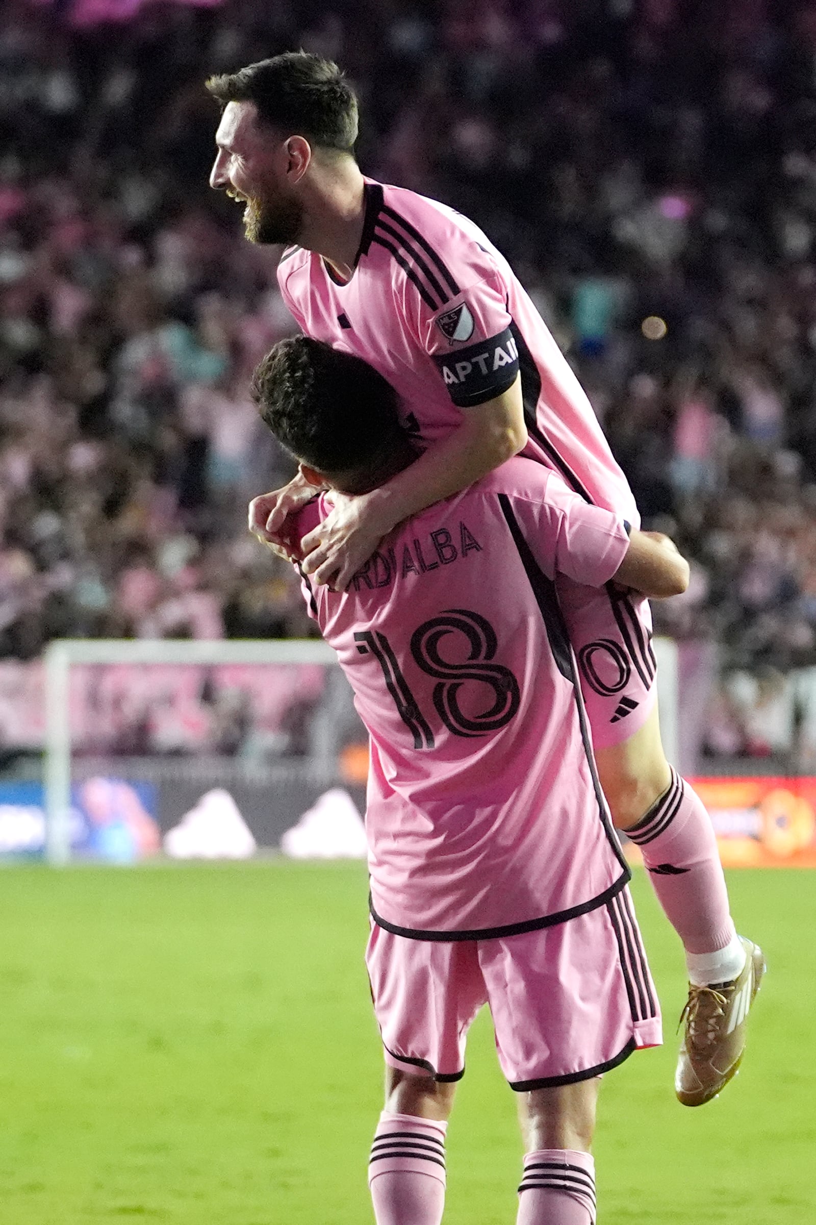 Inter Miami forward Lionel Messi, right, is lifted into the air by Jordi Alba (18) after scoring a goal during the second half of an MLS soccer match against the New England Revolution, Saturday, Oct. 19, 2024, in Fort Lauderdale, Fla. (AP Photo/Lynne Sladky)