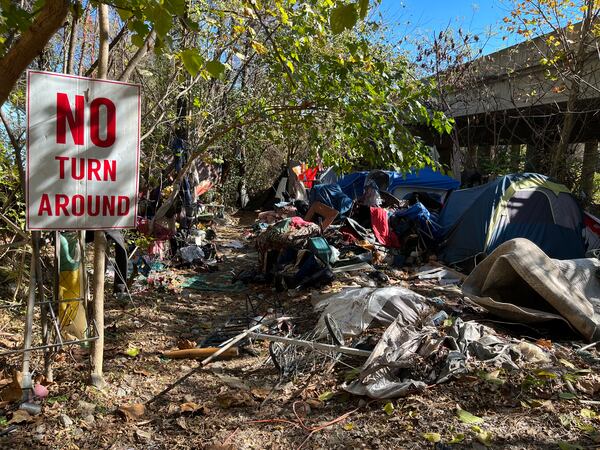 Some residents put out signs and knickknacks to mark where they lived at The Hill, an encampment of people who are homeless. They also left behind large amounts of debris and trash. Work crews began clearing the site in Buckhead on Monday, Nov. 21, 2022. Partners for Home, a nonprofit working with the city of Atlanta, offered services and subsidized housing for residents of the encampment, which is near the intersection of Lenox Road and Buford Highway and close to a southbound I-85 ramp to Georgia 400. MATT KEMPNER / AJC