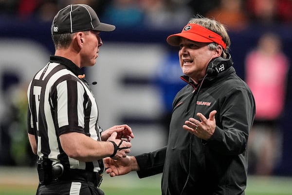 Georgia head coach Kirby Smart speaks with an official during the first half of the Southeastern Conference championship NCAA college football game against Texas, Saturday, Dec. 7, 2024, in Atlanta. (AP Photo/John Bazemore)