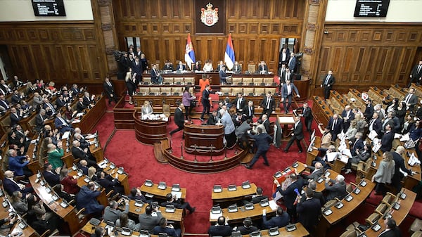 In this grab taken from video provided by RTS Serbia, lawmakers scuffle in parliament, in Belgrade, Serbia, Tuesday, March 4, 2025. (RTS Serbia via AP)